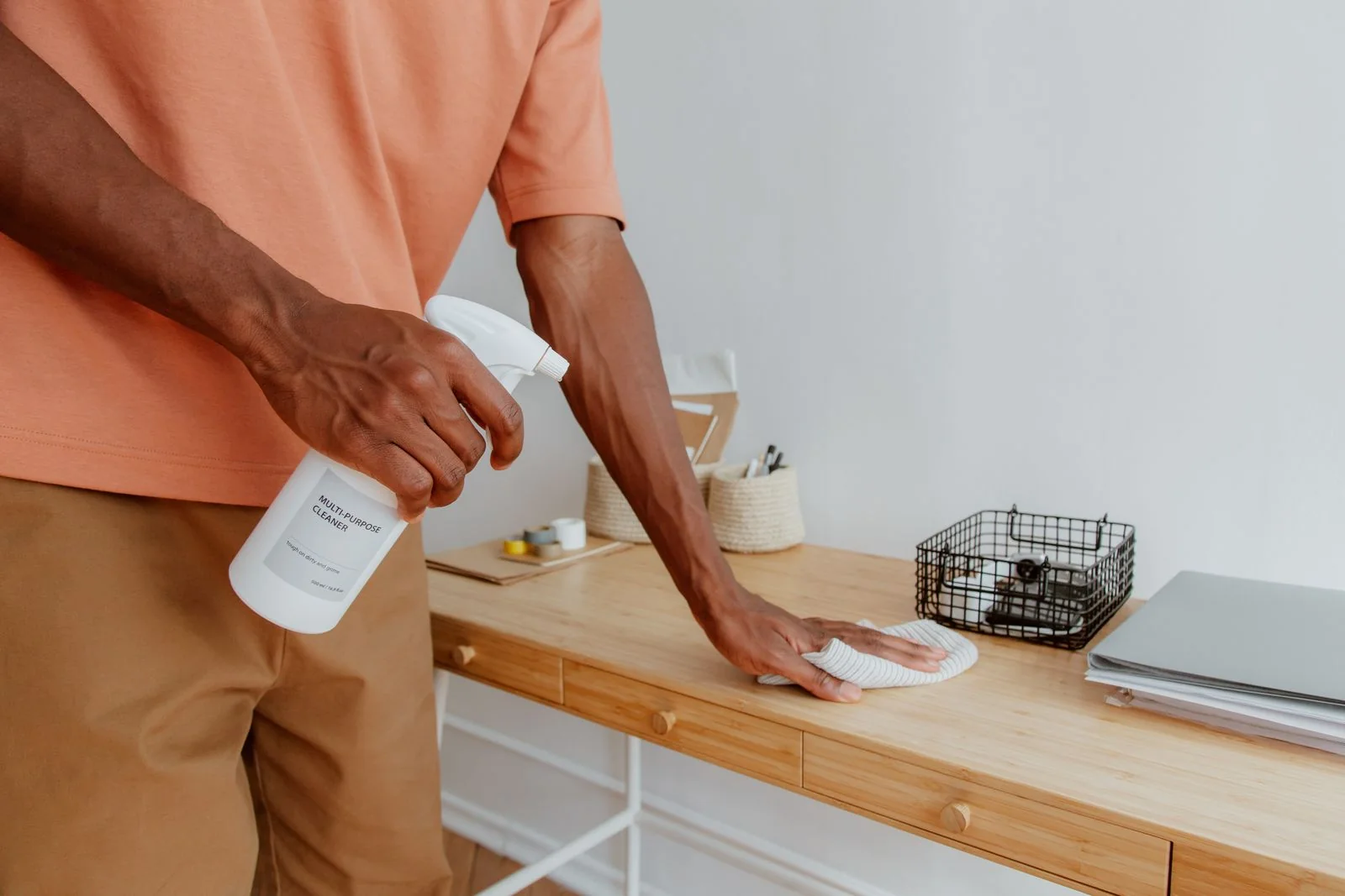 Person wiping a kitchen counter.