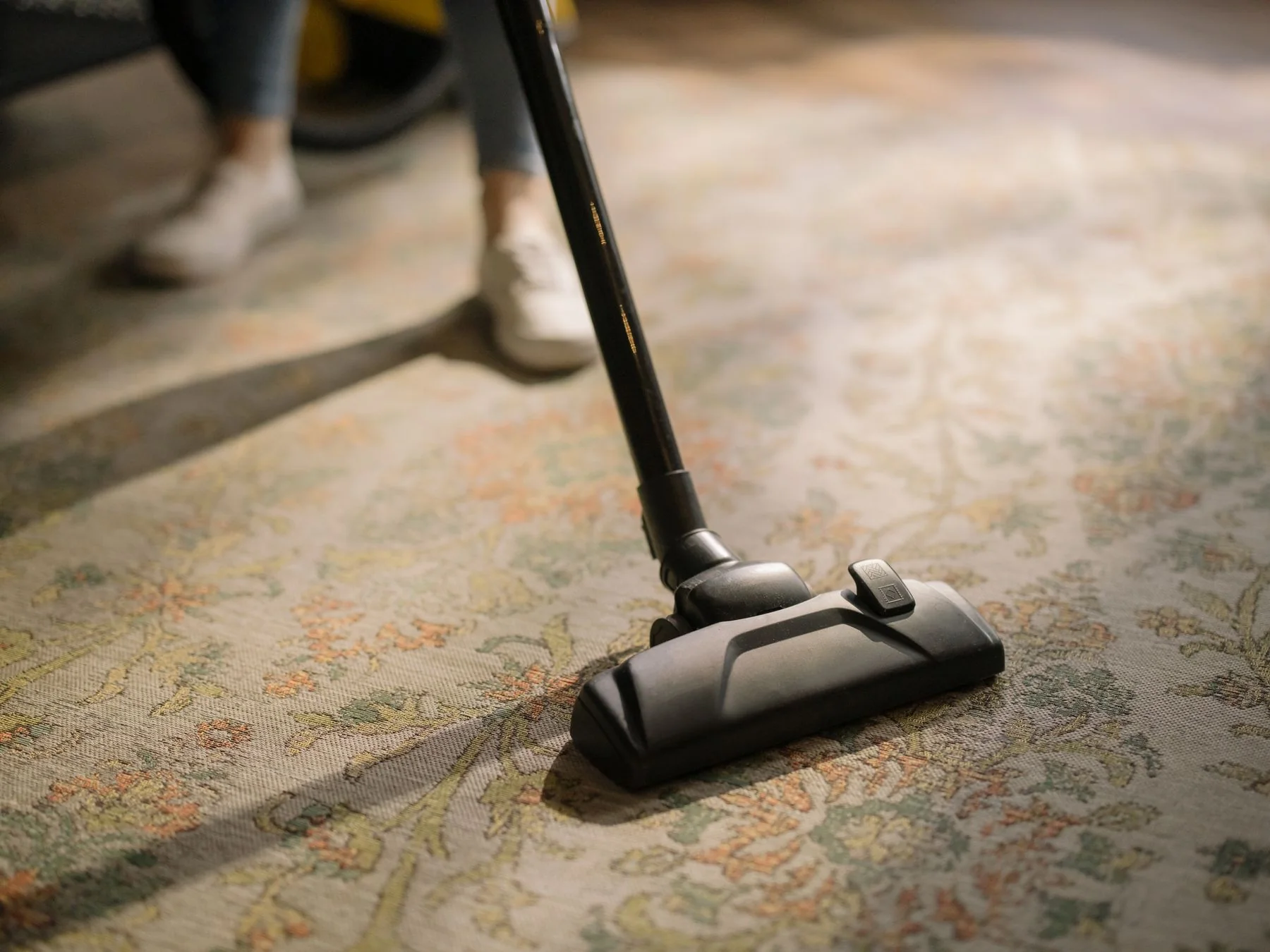 Vacuum cleaner lifting dust from a carpet.